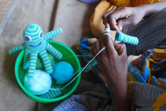 A Global Mothers artisan in Bangladesh knitting an Octopus Rattle